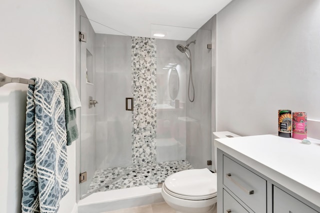 bathroom with vanity, toilet, tile patterned flooring, and an enclosed shower