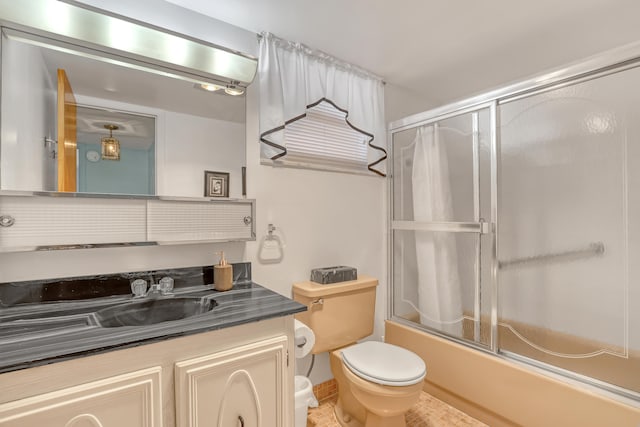 full bathroom featuring shower / bath combination with glass door, vanity, and toilet