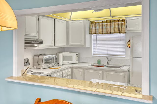 kitchen featuring extractor fan, white appliances, white cabinetry, and sink