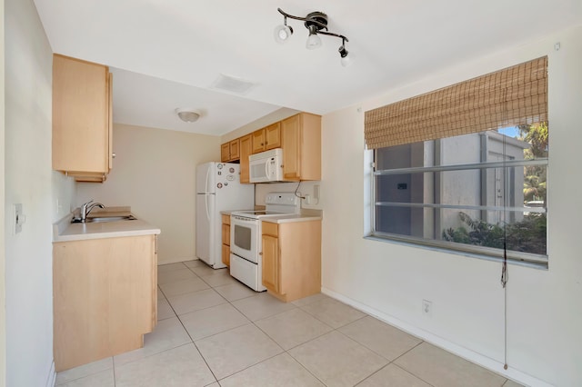 kitchen with light tile patterned floors, white appliances, light brown cabinetry, and sink