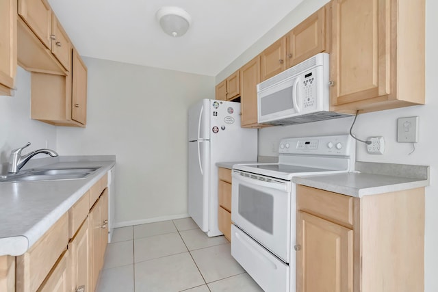 kitchen with white appliances, light brown cabinetry, sink, and light tile patterned flooring