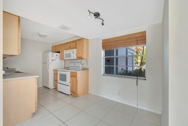 kitchen with light tile patterned floors, white appliances, sink, and light brown cabinets