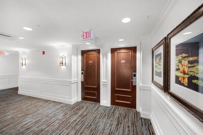 foyer with ornamental molding and carpet floors