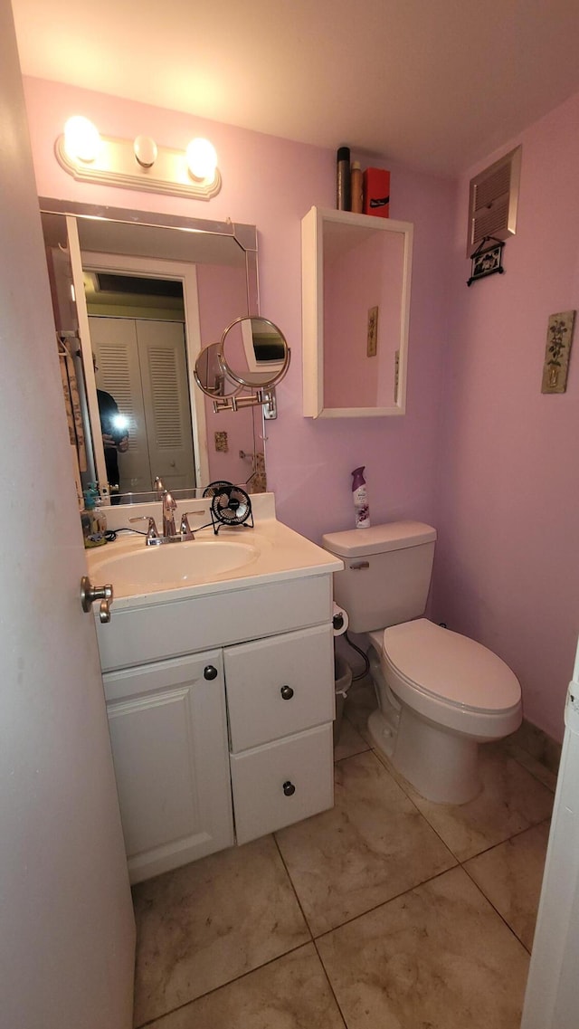 bathroom with vanity, toilet, and tile patterned floors