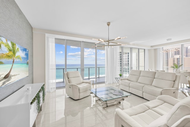 living room featuring expansive windows, a chandelier, a view of the beach, and a water view