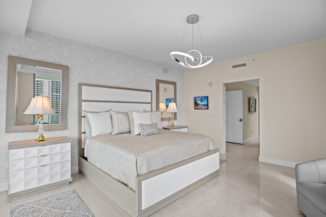 bedroom featuring an inviting chandelier