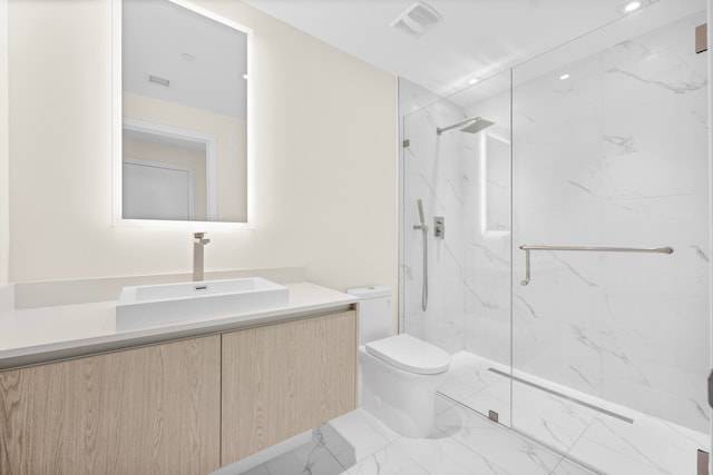 bathroom featuring a shower with shower door, vanity, and toilet