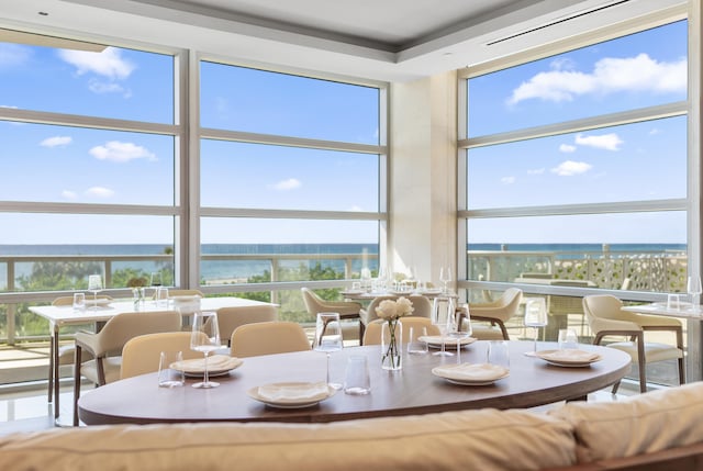 dining space featuring a water view