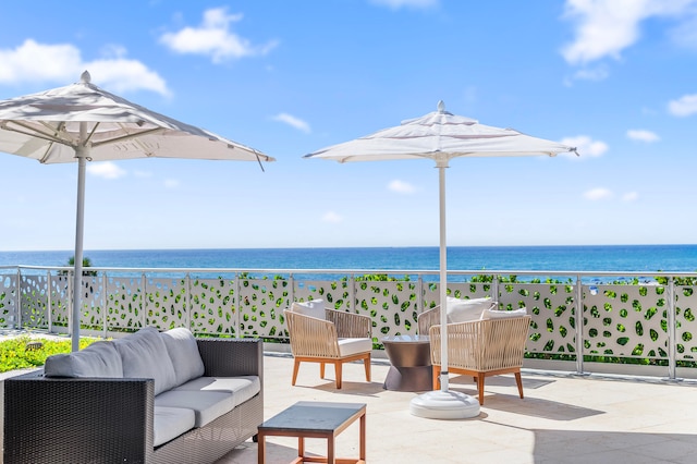 balcony featuring an outdoor hangout area, a patio area, a water view, and a view of the beach