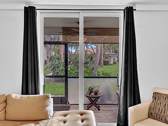 doorway featuring ceiling fan and hardwood / wood-style flooring