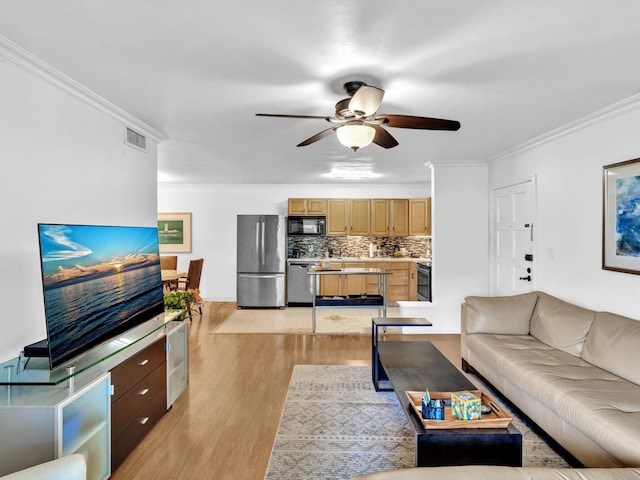 living room with crown molding, light hardwood / wood-style floors, and ceiling fan