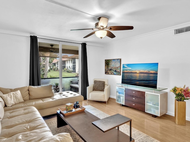 living room featuring ornamental molding, ceiling fan, and light hardwood / wood-style flooring