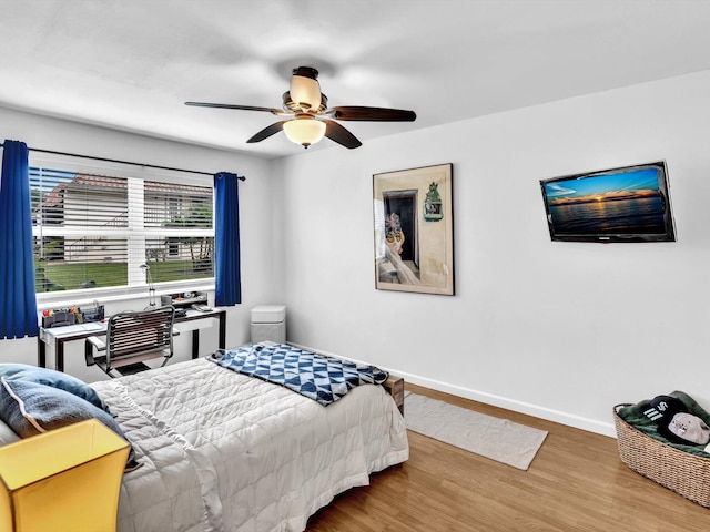 bedroom with ceiling fan and hardwood / wood-style flooring