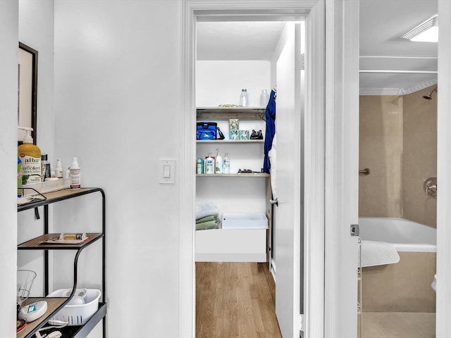 interior space with shower / bath combination and wood-type flooring