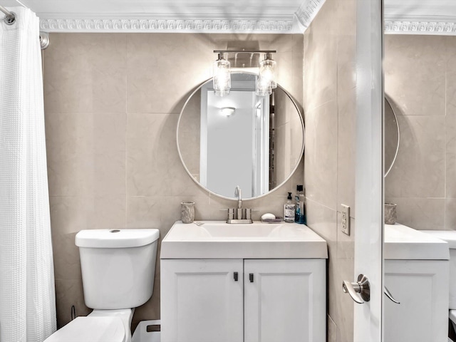 bathroom featuring tile walls and toilet