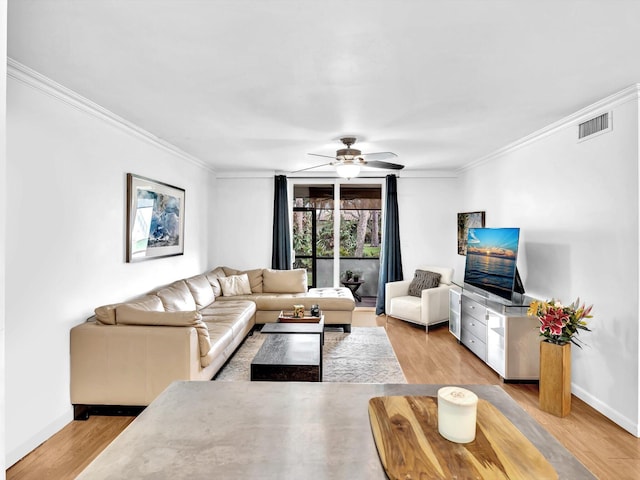 living room featuring crown molding, ceiling fan, and light hardwood / wood-style flooring