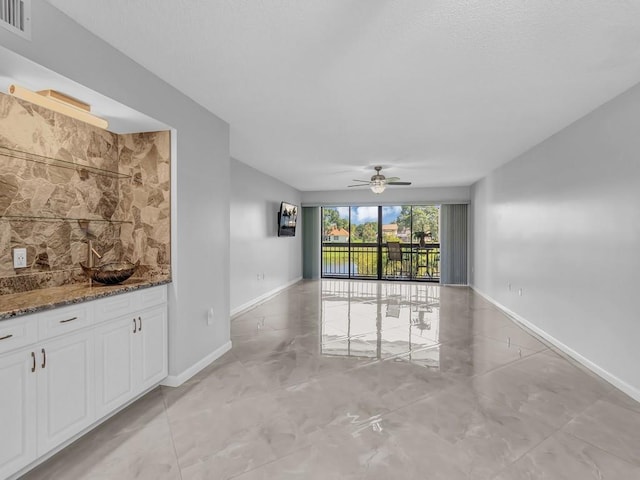 interior space featuring ceiling fan