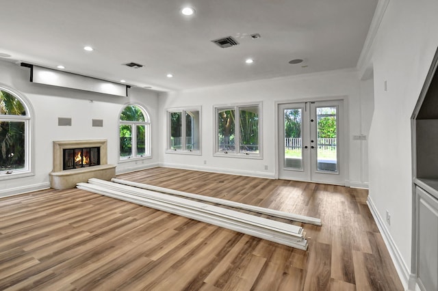 unfurnished living room featuring french doors and hardwood / wood-style floors