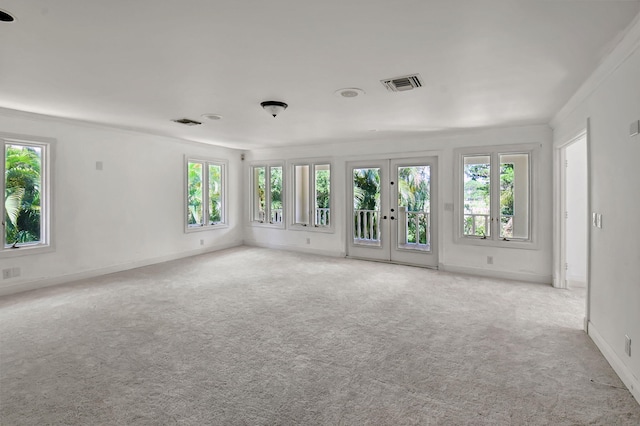 unfurnished room with french doors and light colored carpet