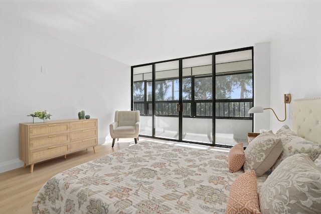 bedroom featuring light hardwood / wood-style floors and access to exterior