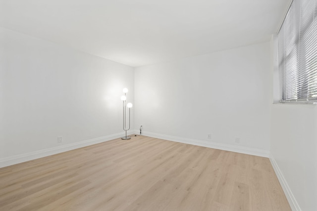 empty room with light hardwood / wood-style flooring