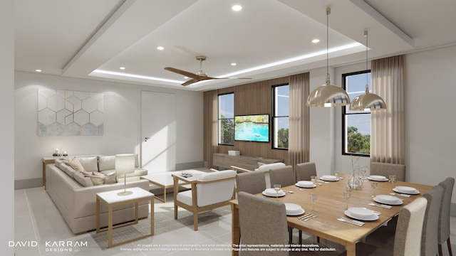 living room with light tile flooring, ceiling fan, and a tray ceiling