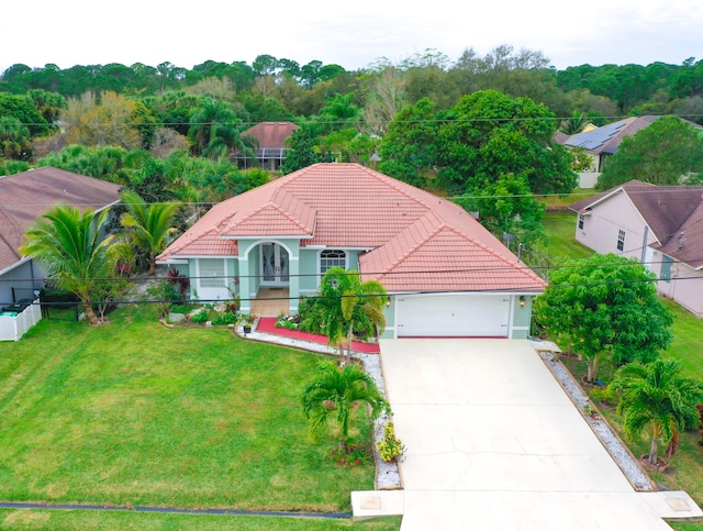 mediterranean / spanish home with a front lawn and a garage