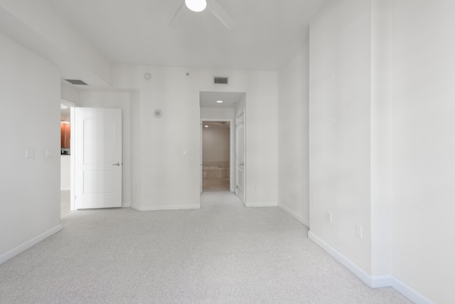 carpeted spare room featuring ceiling fan