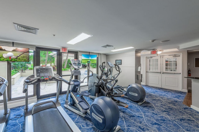 workout area with a healthy amount of sunlight and dark colored carpet