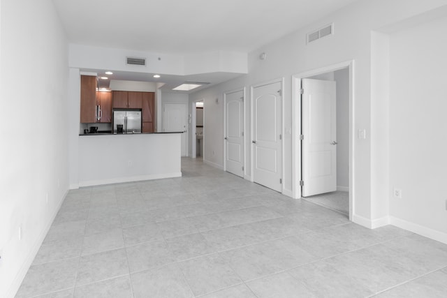 unfurnished living room with light tile patterned floors