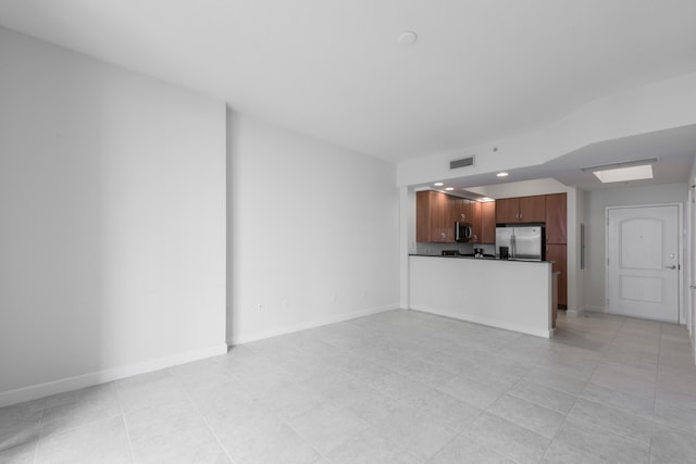 unfurnished living room with light tile patterned flooring