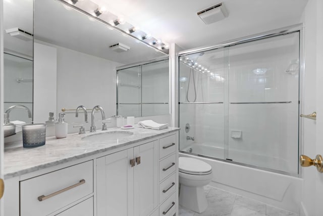 full bathroom with tile flooring, shower / bath combination with glass door, toilet, and vanity with extensive cabinet space