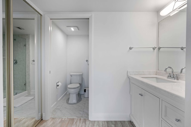 bathroom with toilet, tile floors, and large vanity