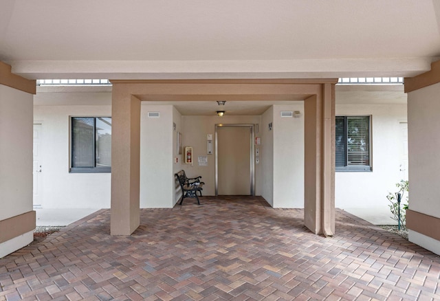 doorway to property with a patio