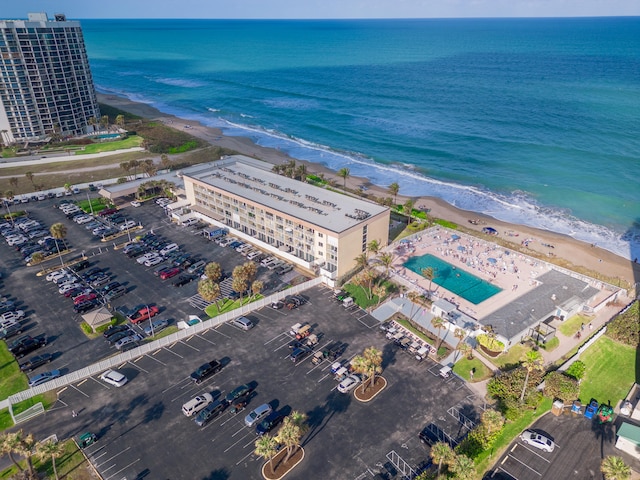 birds eye view of property with a view of the beach and a water view