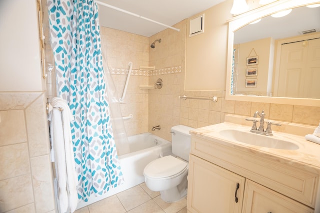 full bathroom featuring tile patterned flooring, visible vents, toilet, vanity, and tile walls