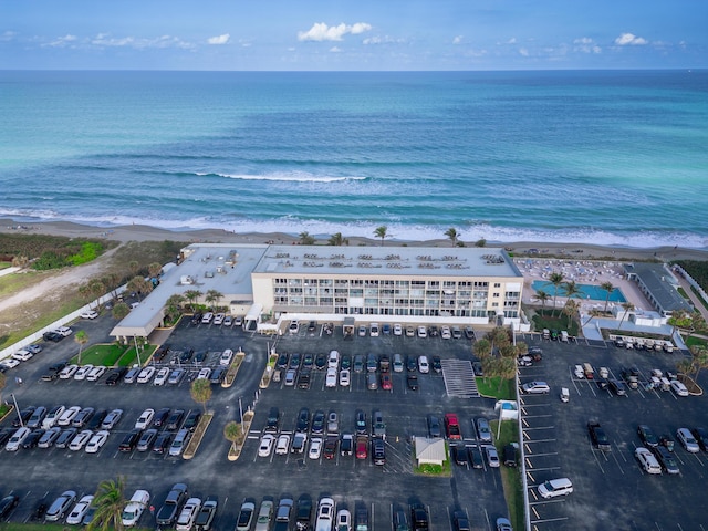 bird's eye view with a water view and a beach view