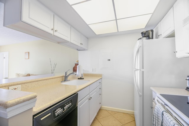kitchen featuring white cabinets, black dishwasher, light tile patterned floors, and a sink