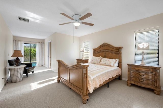 bedroom featuring light colored carpet and ceiling fan