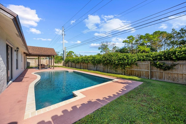 view of pool featuring a lawn and a patio area