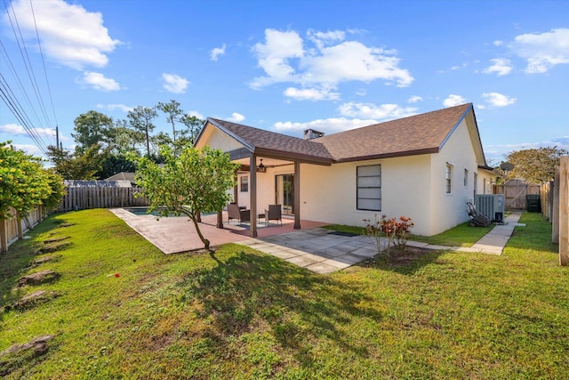 rear view of property featuring central AC, a patio area, and a yard