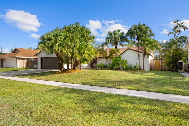 view of front of property with a front lawn and a garage