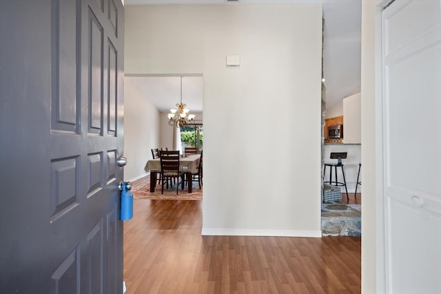 foyer with a chandelier and light hardwood / wood-style flooring