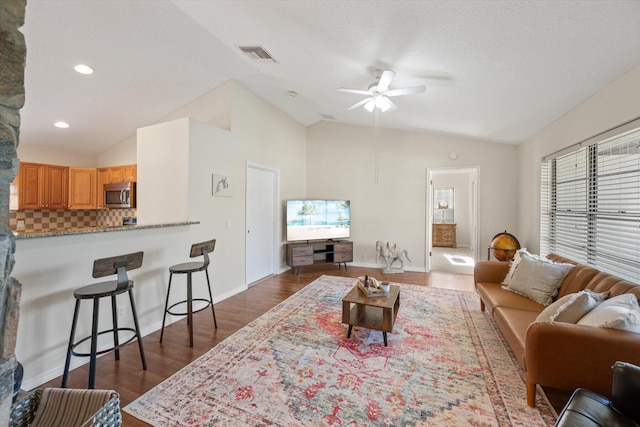 living room with high vaulted ceiling, ceiling fan, and dark hardwood / wood-style flooring