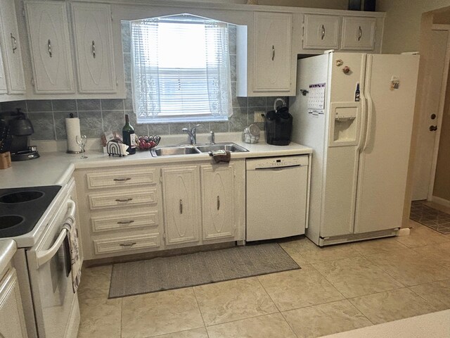 kitchen featuring white appliances, sink, light tile floors, a textured ceiling, and tasteful backsplash