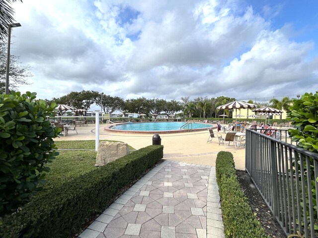 view of swimming pool with a patio