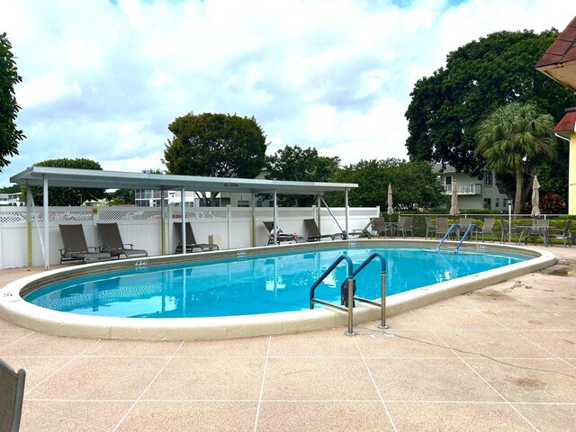 view of swimming pool with central AC and a patio