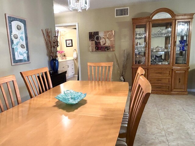 dining room featuring a textured ceiling and a chandelier