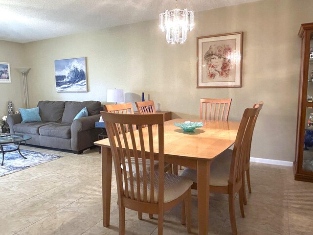 living room with a textured ceiling, ceiling fan, and light tile floors