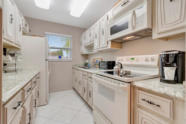 kitchen with white appliances, light tile flooring, sink, and light stone counters